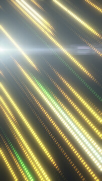 Diagonal glowing dotted light streaks in gold and green tones with soft bokeh blur, forming an abstract technology and motion background