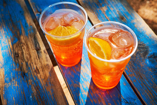 Two cups of ice-cooled Spritz with orange slice