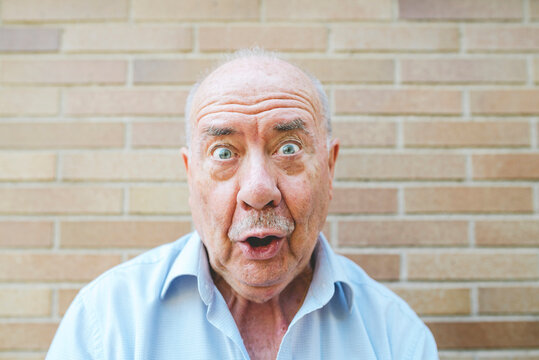 Portrait of senior man pulling funny faces