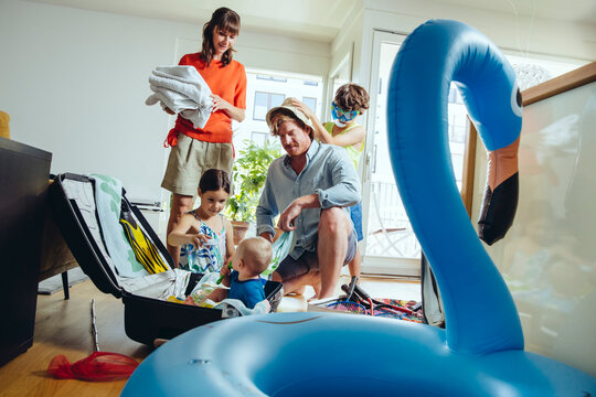 Family of five packing for holiday trip