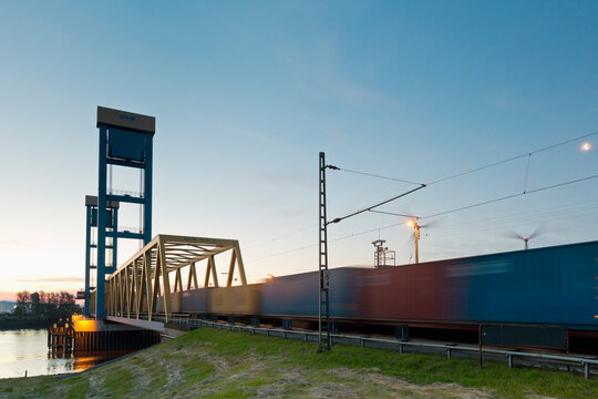 Germany, Hamburg, Kattwyk bridge, Train with containers, Wind wheels in the background