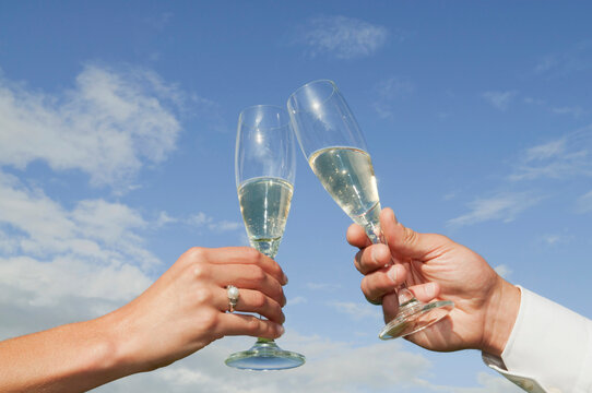 Germany, Bavaria, Couple toasting with champagne glasses, close-up of hands