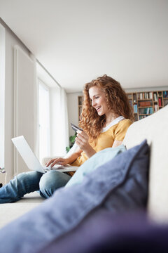Smiling woman at home shopping online