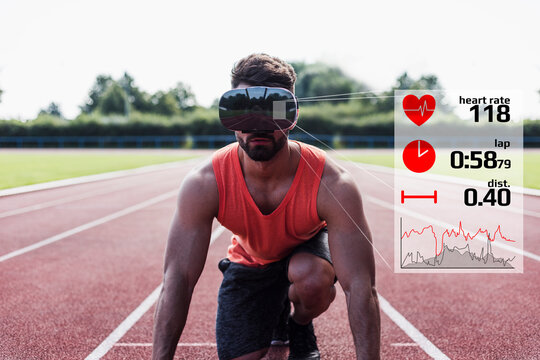 Athlete in starting position on tartan track with data emerging from VR glasses