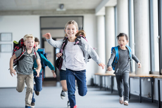 Eager students hurrying through the school hallway with enthusiasm and anticipation