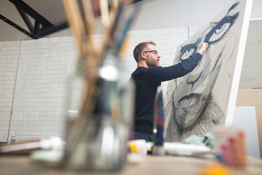 Man checking drawing in studio