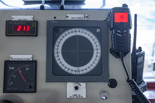 Marine navigation equipment with compass repeater vhf radio and digital rpm display on a ship bridge command console