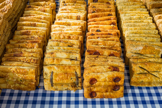 Assorted Savory Pastry Slices on Display at French Outdoor Market