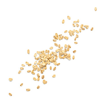 Scattered oat flakes on a clean white background.  Top view of oat flakes isolated.