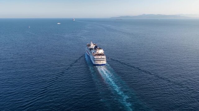 Panoramic aerial view of a cruise ship sailing over blue ocean into the sunset with copy space as a concept for travel and vacation