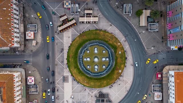 Rotating aerial time lapse view of the Omonia Square in the city centre of Athens, Greece, with street and pedestrian traffic during dusk