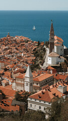 Obraz premium Aerial view of Piran old town with Church of St. George bell tower and Adriatic Sea, Slovenia, Mediterranean Europe