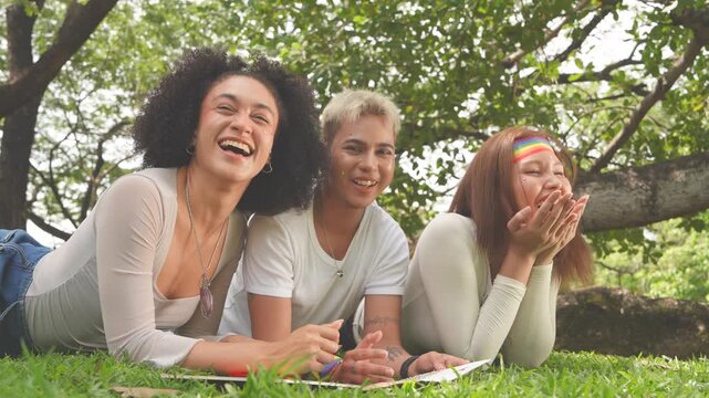 Latina women in love with cross-dressing men and tomboys, happily kissing and wearing Pride flags and celebratory outfits for parades in parks, all part of the Pride and LGBTQ festival concept