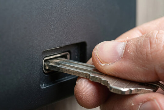 Hand inserting metallic passkey into port macro