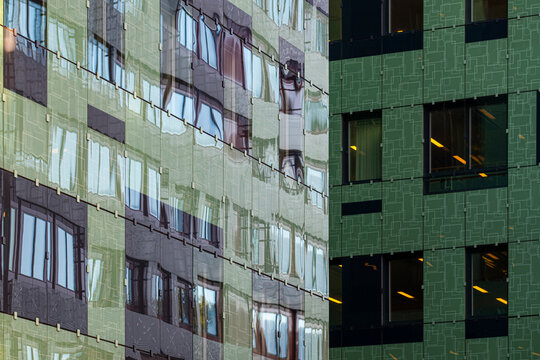 A green building facade becomes an abstract surface in Stockholm, Sweden, where modern urban city architecture is read through windows and texture