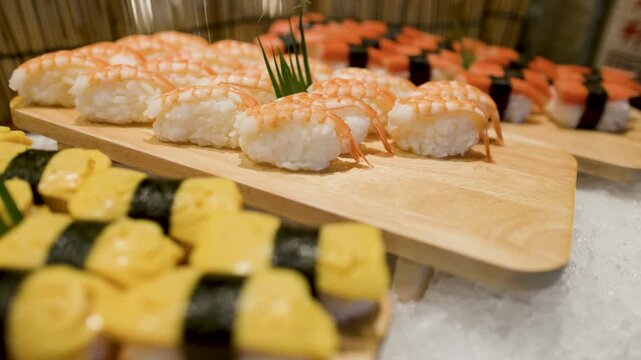 Assorted Japanese Sushi Nigiri Displayed on Wooden Boards at Buffet