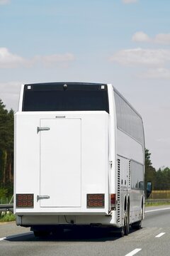 Large bus driving under clear sky
