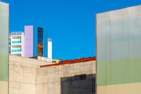 Concrete, glass and blue sky shape a quiet building facade in Benidorm, Spain, giving modern urban architecture restrained coastal geometry