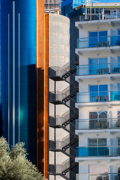 Contrasting towers in Benidorm, Spain set modern urban architecture between blue glass, white balconies and sunlit building facade geometry