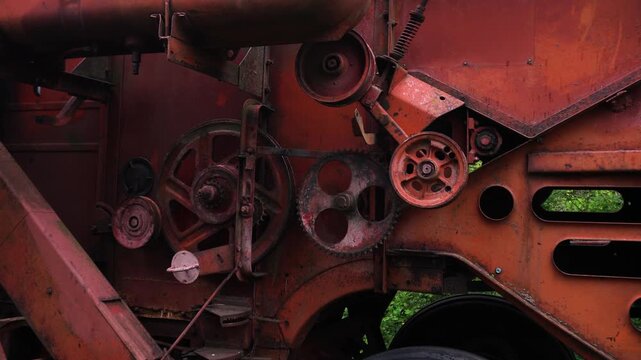 old red combine harvester pulleys for moving belts for threshing wheat barley and soybeans in summer and fall