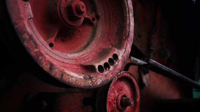 old red combine harvester pulleys for moving belts for threshing wheat barley and soybeans in summer and fall