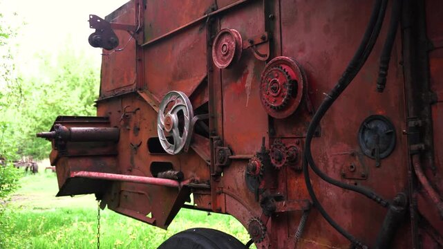 old red combine harvester pulleys for moving belts for threshing wheat barley and soybeans in summer and fall