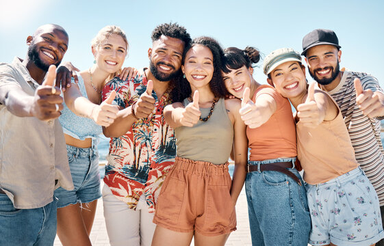 Happy, thumbs up and portrait of friends on beach for summer holiday, vacation and weekend. Travel, tourism and men with women by ocean for hangout, spring break and emoji on promenade outdoor
