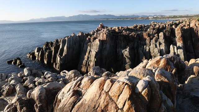 rocky coastline of DeKelders, Gansbaai, South Africa at sunset
