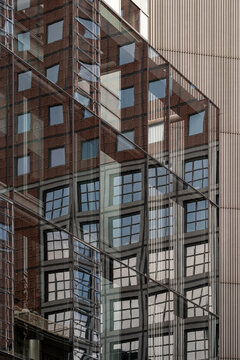 Brick and glass reflections intersect on a modern building facade in Frankfurt, Germany, giving urban architecture a layered geometric face