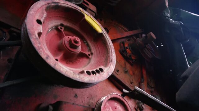 old red combine harvester pulleys for moving belts for threshing wheat barley and soybeans in summer and fall