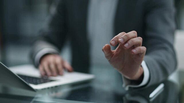 Focused professional fingers hover above a laptop keyboard