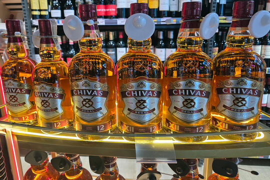 Wroclaw, Poland, March 14, 2026: Chivas Regal 12-Year Scotch Whisky Bottles on Liquor Store Display Shelf
