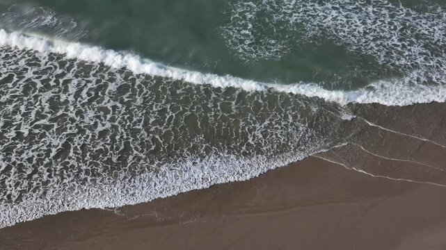 Top down aerial drone view of Atlantic waves breaking on sandy beach near Dakhla Morocco ideal for travel nature and coastal projects