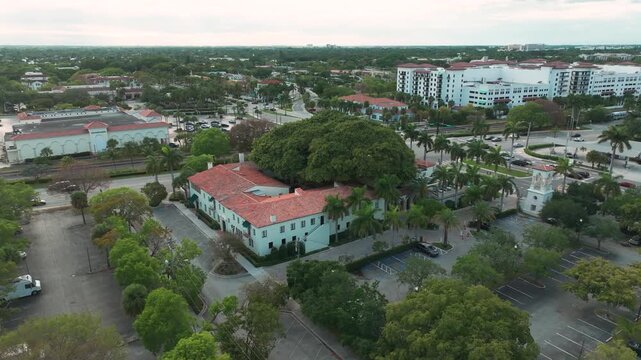 Aerial elegance over The Addison of Boca Raton &mdash; a historic Florida wedding venue framed by sprawling banyan trees, terracotta roofs, and lush tropical gardens.