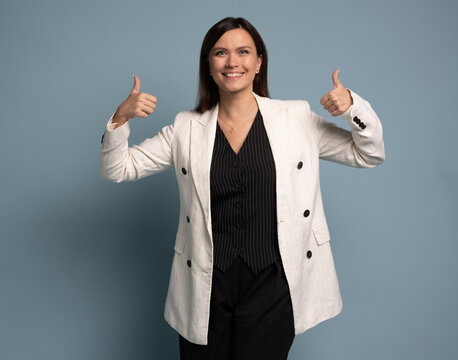 Middle-aged happy business woman shows thumb up