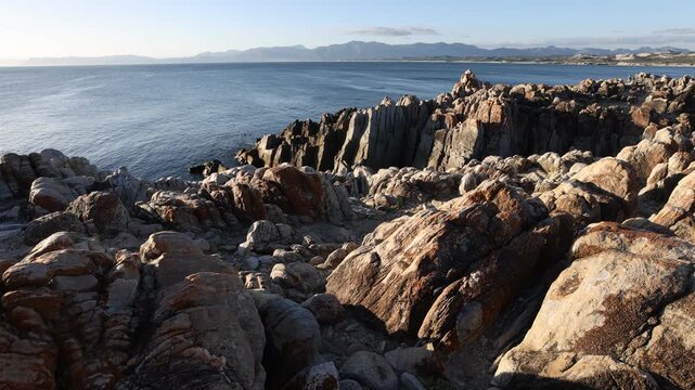 rocky coastline of DeKelders, Gansbaai, South Africa at sunset