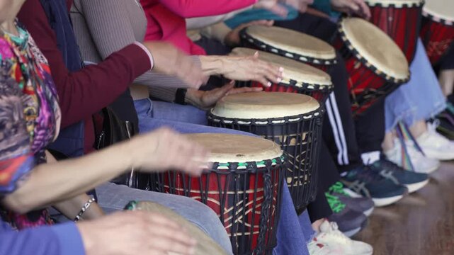elderly people Playing African Drums Together in a Rhythmic Group Session