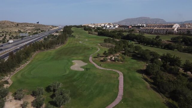Aerial reveal of the Alenda golf course, next to the A-31 highway. Monforte del Cid, Spain.