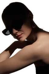 Close up fashion portrait of woman in sunglasses with glossy skin and hard light. Concept of beauty editorial, eyewear campaign, luxury accessory promo and modern style branding.