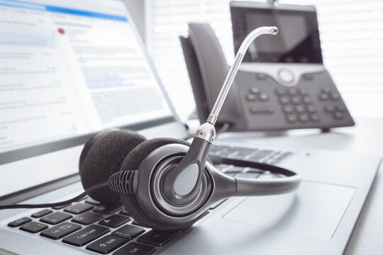 Headset headphones telephone and laptop in call center