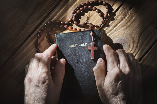 Prayer with a Holy Bible and rosary beads in church, faith, spirtuality and religion