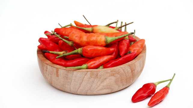 Red cayenne pepper (cabe rawit merah) on wooden bowisolated on white background	