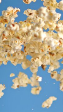 Super slow motion popcorn takes off on a blue background. Filmed on a high-speed camera at 1000 fps. High quality FullHD footage