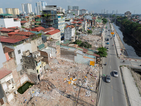 Drone view of demolished housing blocks and cleared construction zone prepared for Tam Trinh Road widening in Hanoi.