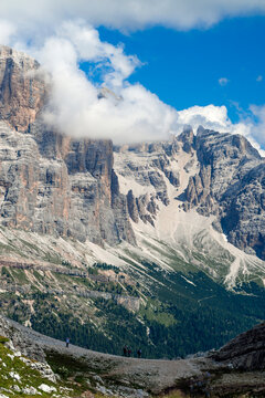 Clouds swirling around vertical rock faces of mountain