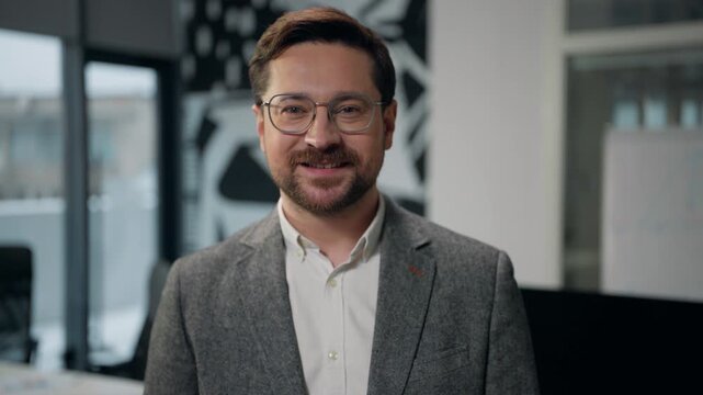 Close up Caucasian adult business man look to side smiling looking at camera smile toothy healthy teeth wearing glasses European middle-aged businessman in office satisfied male expert startup owner