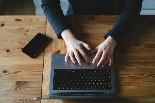 Directly above shot of female freelancer working on laptop