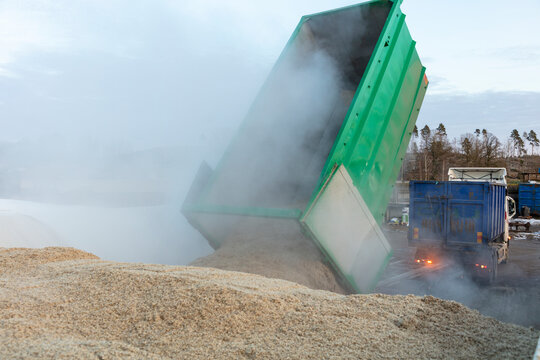 Truck dumping agricultural waste in farm