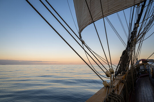 View of intricate ropes and wooden blocks of traditional tall ship sailing in open ocean