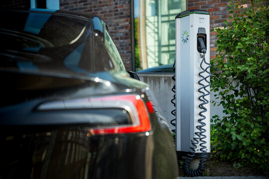 Electric car charging kiosk near building